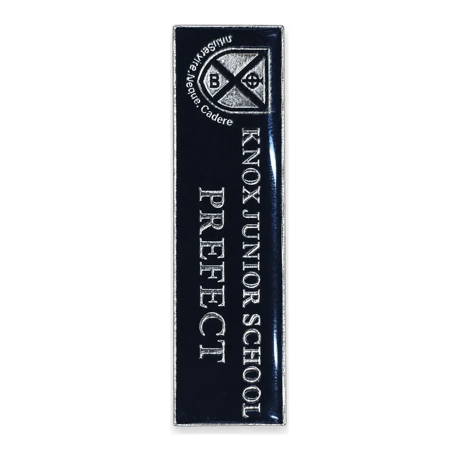 Black and silver pin badge made by J&J United