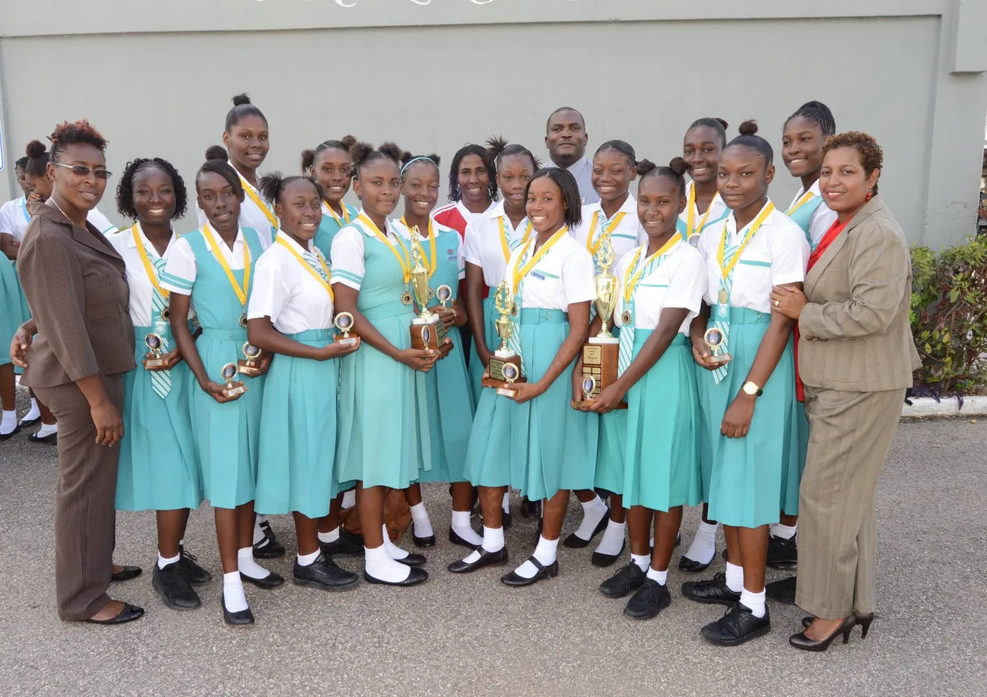 Students in matching J&J school uniforms at an awards ceremony